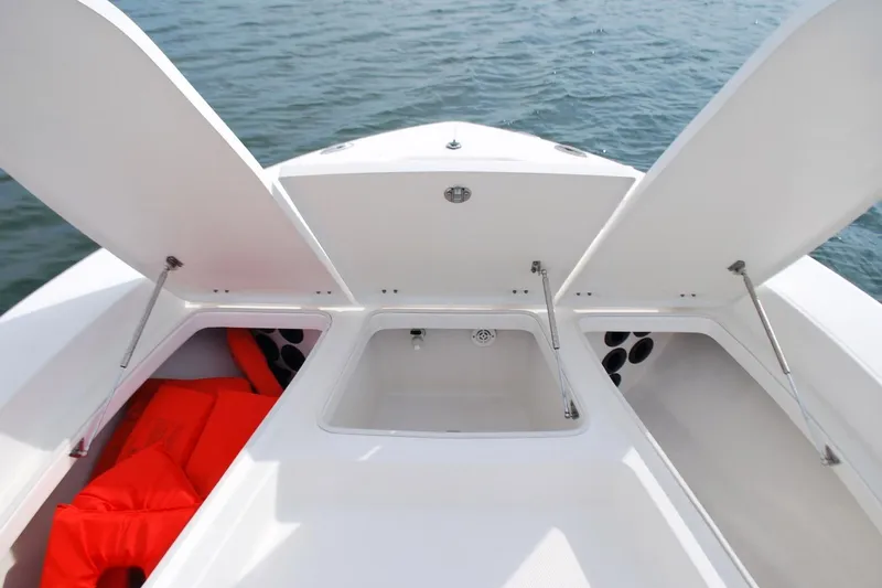 Slide: The Image of Open storage compartments on a 2016 Robalo 226 Cayman boat, with visible life jackets. - 4