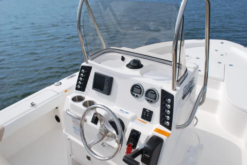 Slide: The Image of 2016 Robalo 226 Cayman boat console with steering wheel and navigation controls. - 7