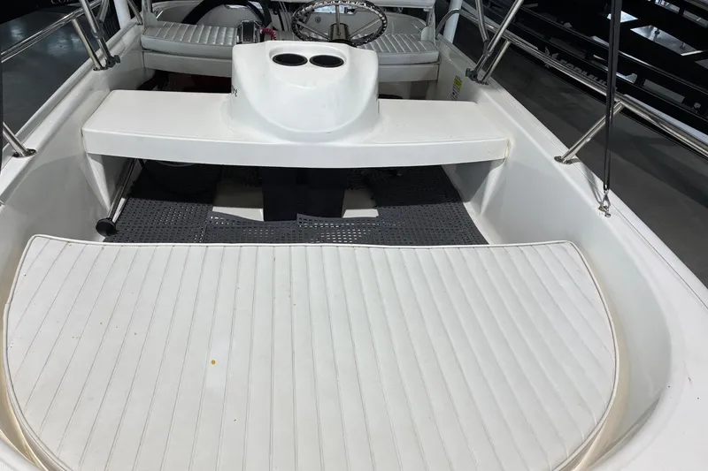 Slide: The Image of 2017 Boston Whaler 110 Sport boat interior with seating and steering wheel. - 2