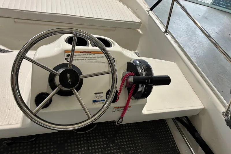 Slide: The Image of Steering console of a 2017 Boston Whaler 110 Sport boat with controls and safety features. - 4