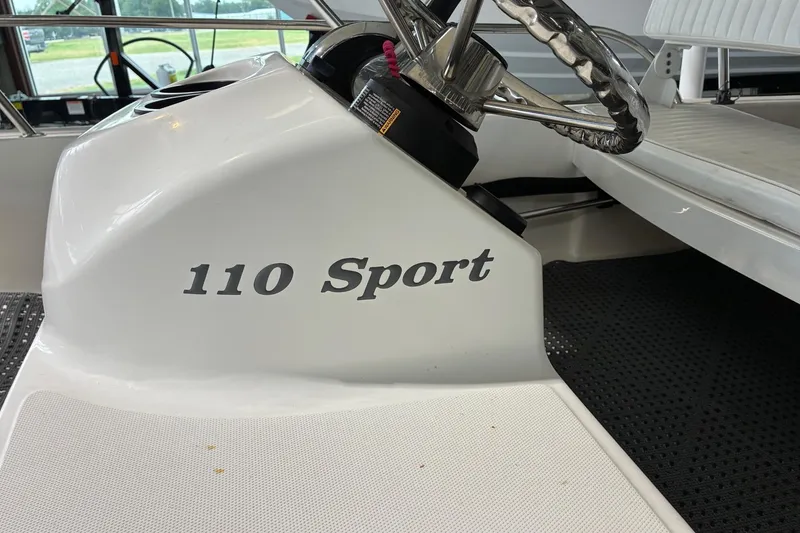 Slide: The Image of 2017 Boston Whaler 110 Sport boat interior with steering wheel and model name. - 5