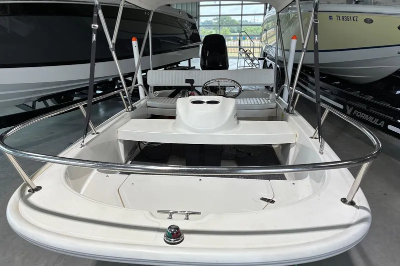 Slide: The Image of 2017 Boston Whaler 110 Sport boat interior with steering wheel and seating. - 6
