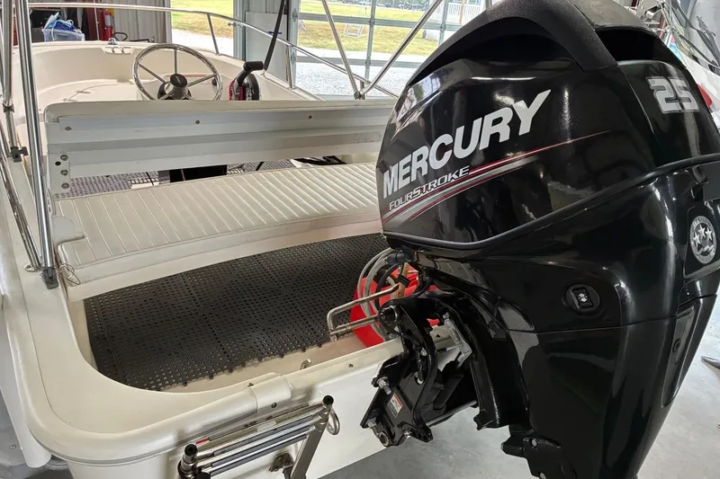 Slide: The Image of 2017 Boston Whaler 110 Sport with Mercury 25 FourStroke engine in a garage setting. - 9