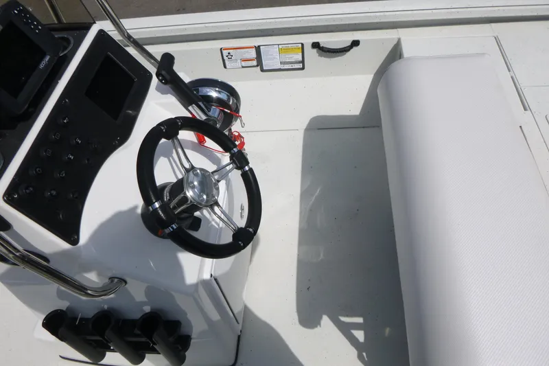 Slide: The Image of 2025 Ranger RB210 boat cockpit with steering wheel and control panel. - 13