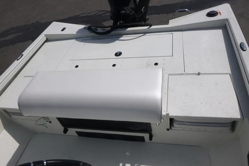 Slide: The Image of 2025 Ranger RB210 boat interior with white seating and storage compartments. - 15