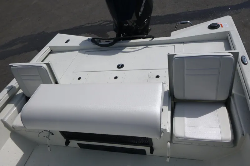 Slide: The Image of 2025 Ranger RB210 boat interior with white cushioned seating and storage compartments. - 17