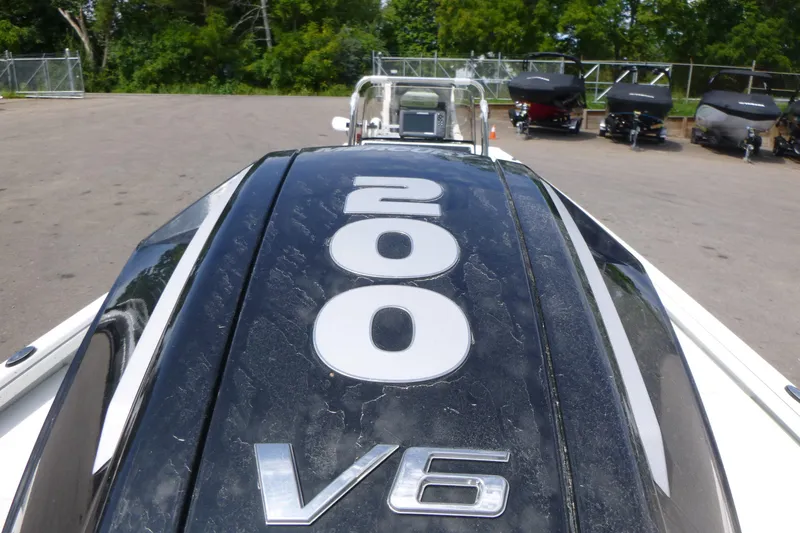 Slide: The Image of Ranger RB210 2025 boat with V6 engine, featuring "200" marking, parked outdoors. - 18