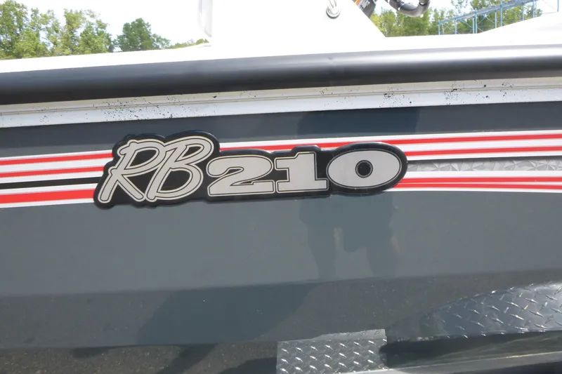 Slide: The Image of 2025 Ranger RB210 boat with red and white stripes on the side. - 19