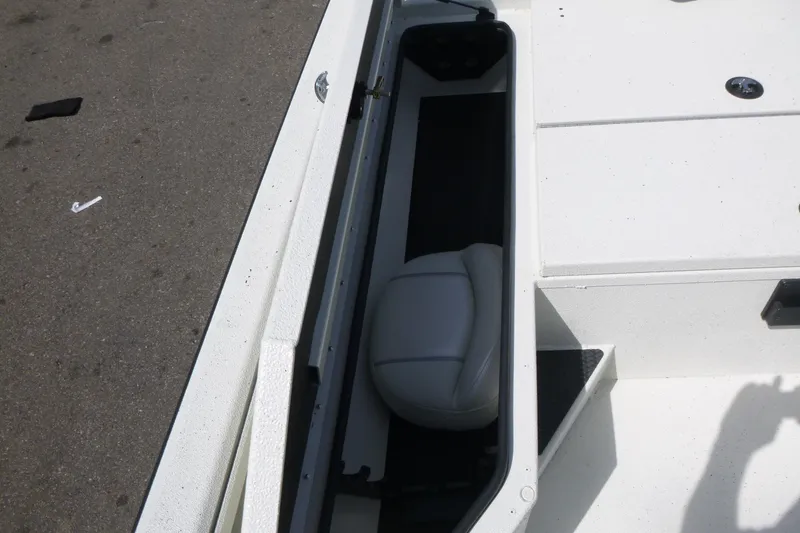 Slide: The Image of 2025 Ranger RB210 boat storage compartment with white interior and seat. - 9