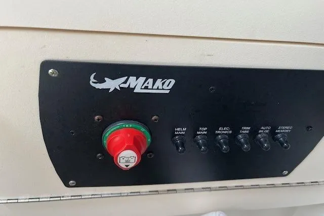 Slide: The Image of Control panel of 2021 Mako 214 CC boat with switches and logo. - 4