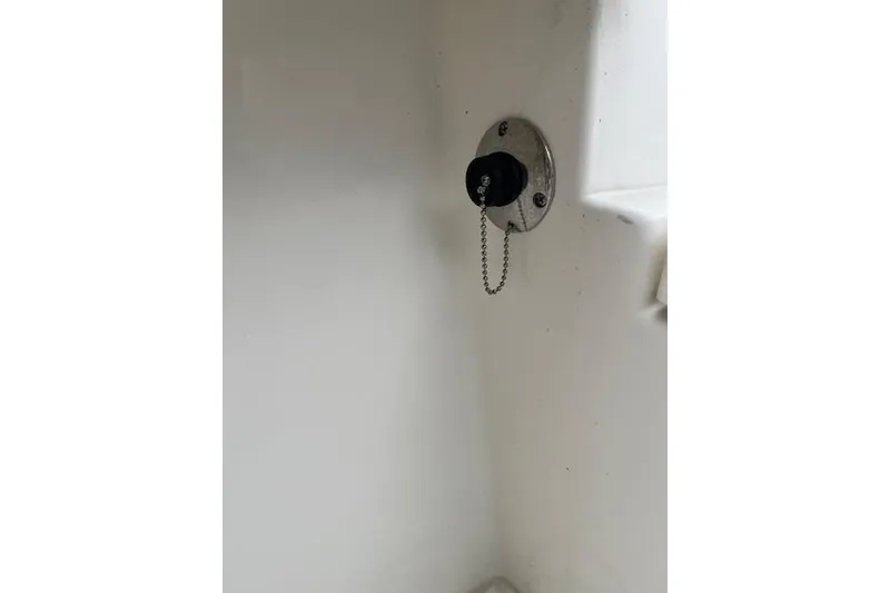 Slide: The Image of 2021 Mako 214 CC boat ignition switch with keychain on white panel. - 6