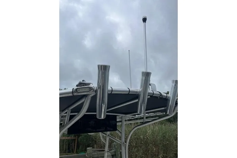 Slide: The Image of 2021 Mako 214 CC boat with rod holders and antenna against cloudy sky. - 7