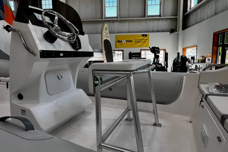 Slide: The Image of 2024 AB Inflatables Oceanus 21 VST boat interior with steering console and seating. - 4