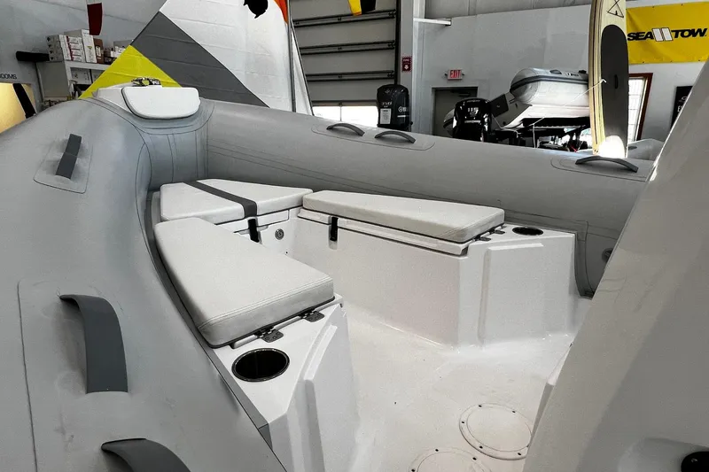 Slide: The Image of 2024 AB Inflatables Oceanus 21 VST interior with cushioned seating and storage compartments. - 5