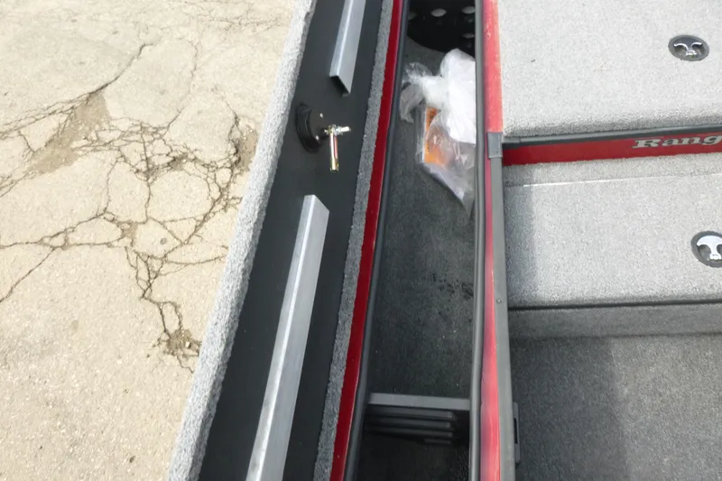 Slide: The Image of 2024 Ranger RT178 boat interior with storage compartment and carpeted flooring. - 12