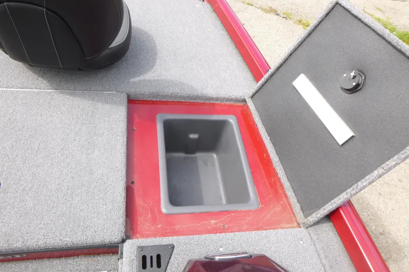 Slide: The Image of 2024 Ranger RT178 boat storage compartment with open lid, featuring gray and red interior. - 13