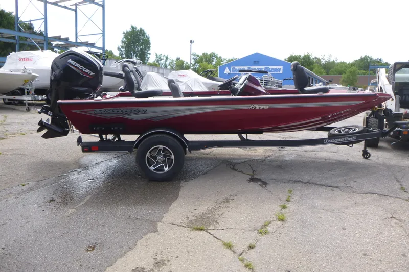 Slide: The Image of 2024 Ranger RT178 boat on trailer, red color, parked outdoors. - 4