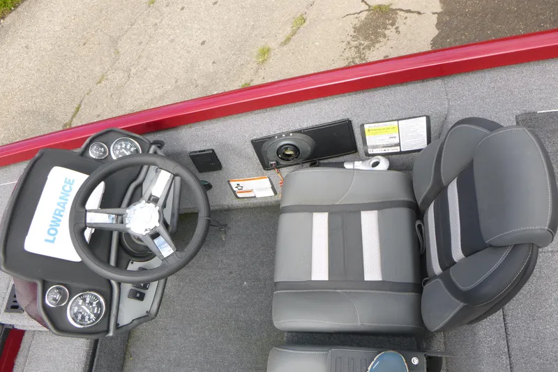 Slide: The Image of 2024 Ranger RT178 boat cockpit with steering wheel, gauges, and cushioned seat. - 7