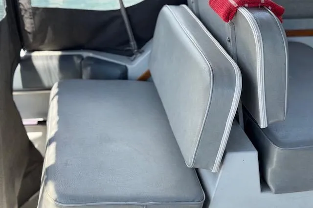 Slide: The Image of 1988 Penn Yan Predator 288 boat interior with gray seating and red strap. - 11