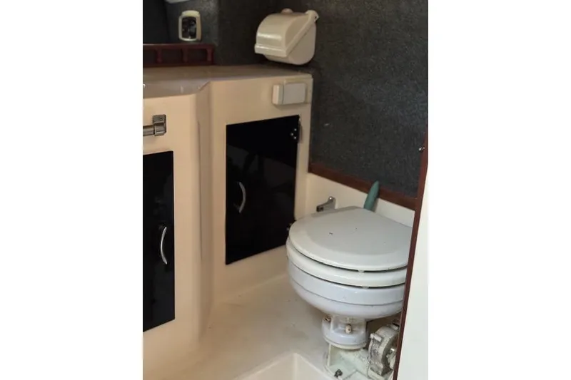 Slide: The Image of 1988 Penn Yan Predator 288 boat interior with toilet and storage cabinets. - 16