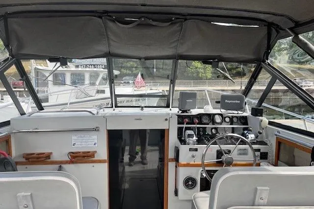 Slide: The Image of 1988 Penn Yan Predator 288 boat interior with steering wheel and control panel. - 30
