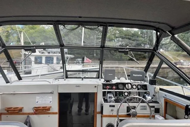 Slide: The Image of 1988 Penn Yan Predator 288 boat cockpit with steering wheel and control panel. - 31