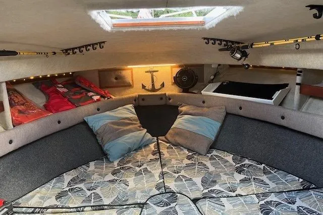 Slide: The Image of Cozy interior of 1988 Penn Yan Predator 288 boat with cushions and fishing rods. - 38