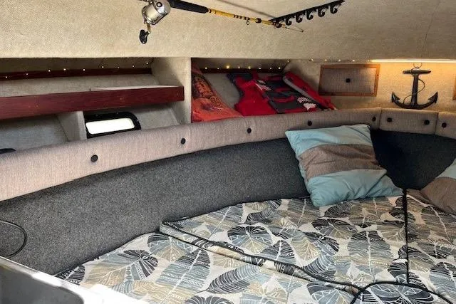 Slide: The Image of 1988 Penn Yan Predator 288 cabin interior with fishing rod, anchor decor, and cozy bedding. - 41