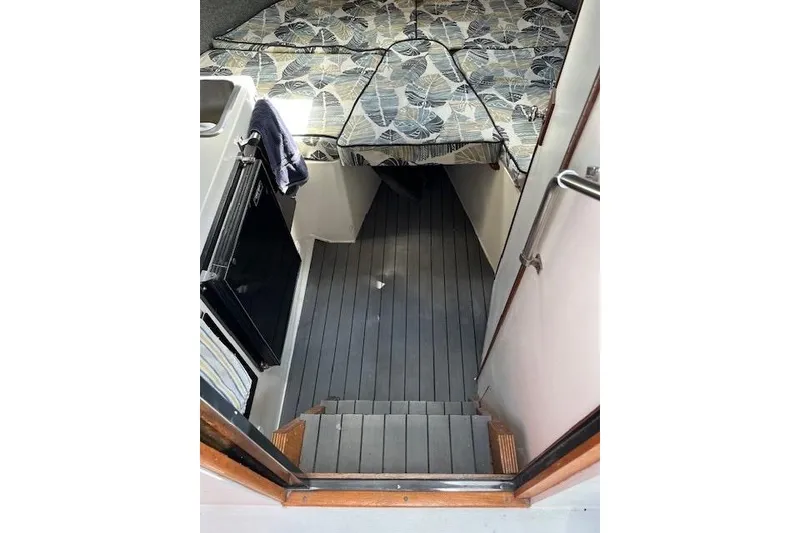 Slide: The Image of Interior cabin of 1988 Penn Yan Predator 288 boat with bed and kitchenette. - 42