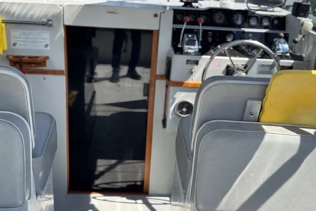 Slide: The Image of 1988 Penn Yan Predator 288 boat interior with steering wheel and control panel. - 8