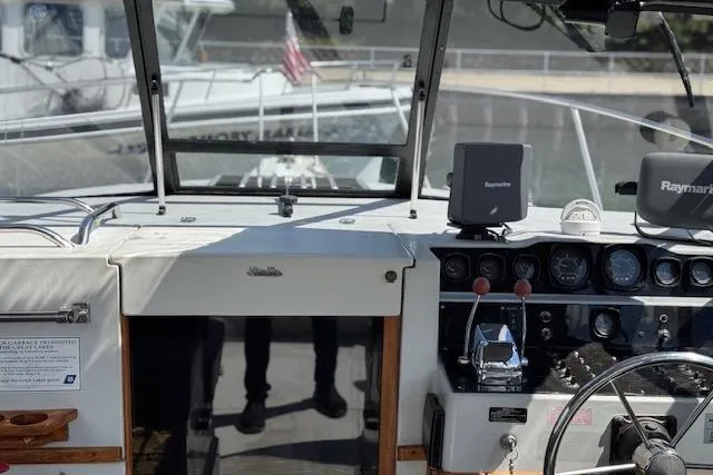 Slide: The Image of Cockpit of 1988 Penn Yan Predator 288 boat with navigation equipment and steering wheel. - 9