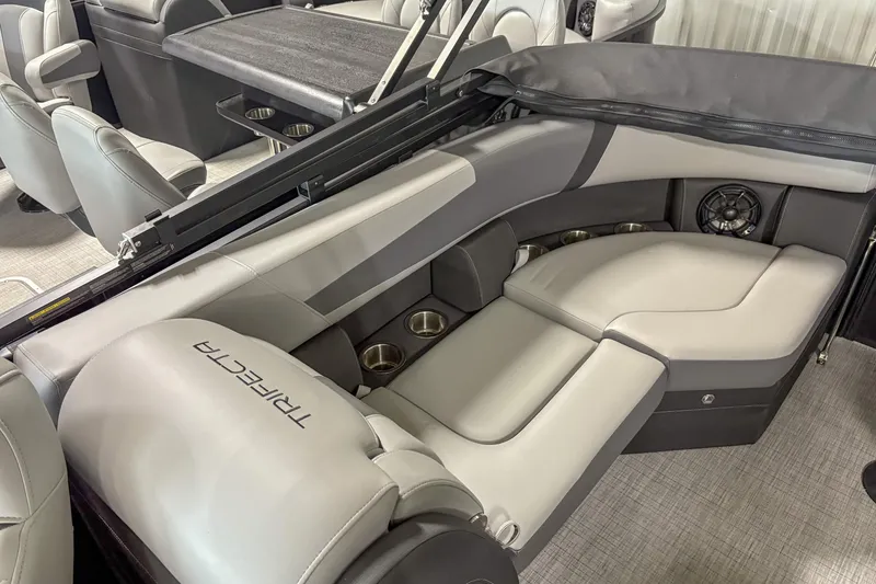 Slide: The Image of Luxurious interior of 2025 Trifecta 22 RF CS pontoon boat with plush seating and cup holders. - 10