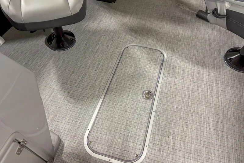 Slide: The Image of 2025 Trifecta 22 RF CS boat interior with gray textured flooring and swivel seats. - 6