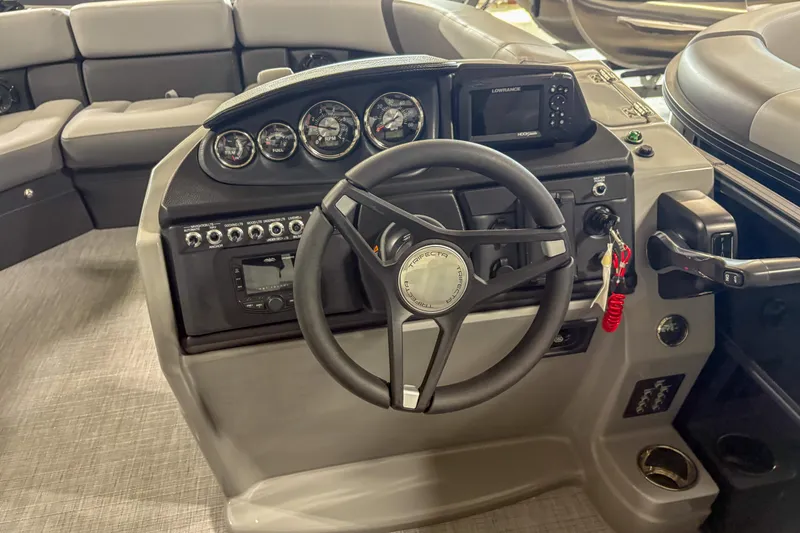 Slide: The Image of 2025 Trifecta 22 RF CS boat dashboard with steering wheel and control panel. - 8