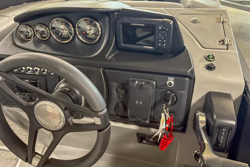 Slide: The Image of Dashboard of 2025 Trifecta 22 RF CS boat with steering wheel and control panel. - 9