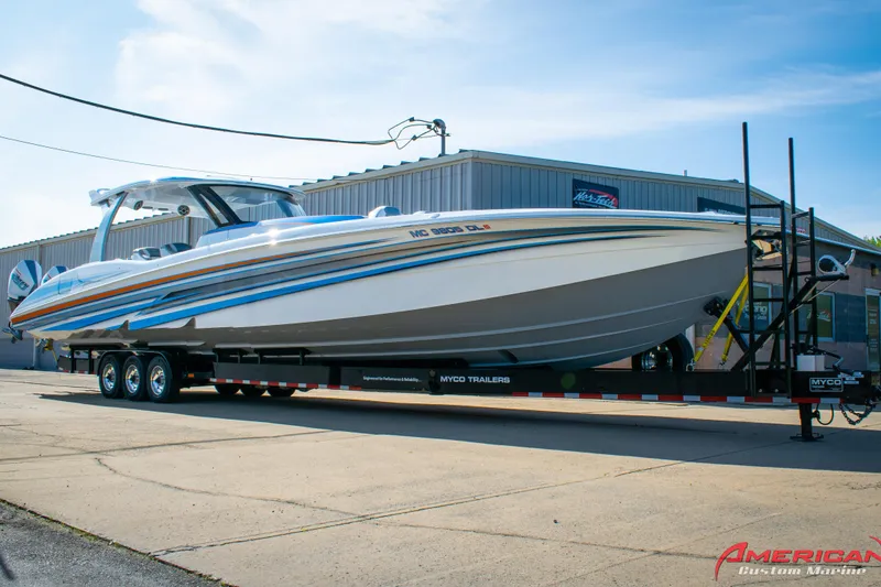 The Image of 2023 MTI 50 V boat on trailer outside American Custom Marine building. - 1