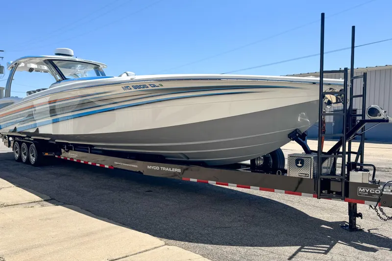 Slide: The Image of 2023 MTI 50 V boat on Myco trailer, parked outdoors. - 13