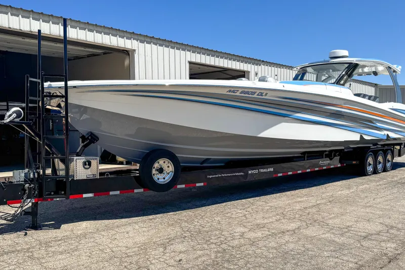 Slide: The Image of 2023 MTI 50 V boat on trailer outside a warehouse. - 15