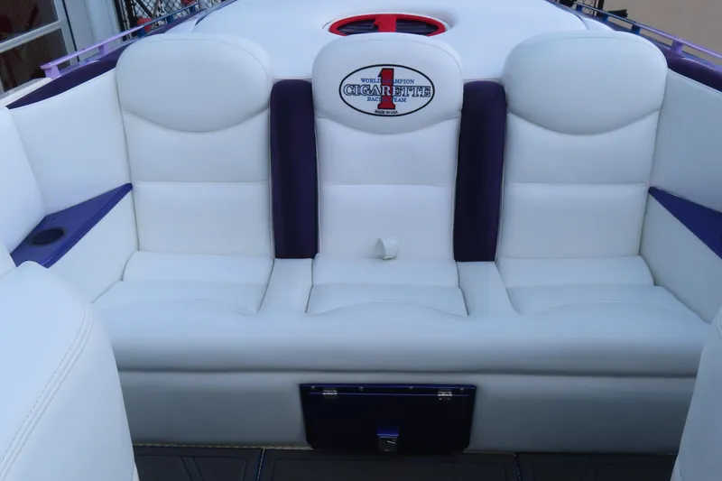 Slide: The Image of 2004 Cigarette 38 Top Gun TS boat interior with white and purple seating. - 14