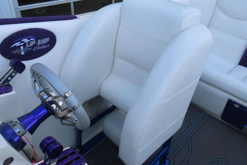 Slide: The Image of 2004 Cigarette 38 Top Gun TS boat interior with white seating and purple accents. - 22