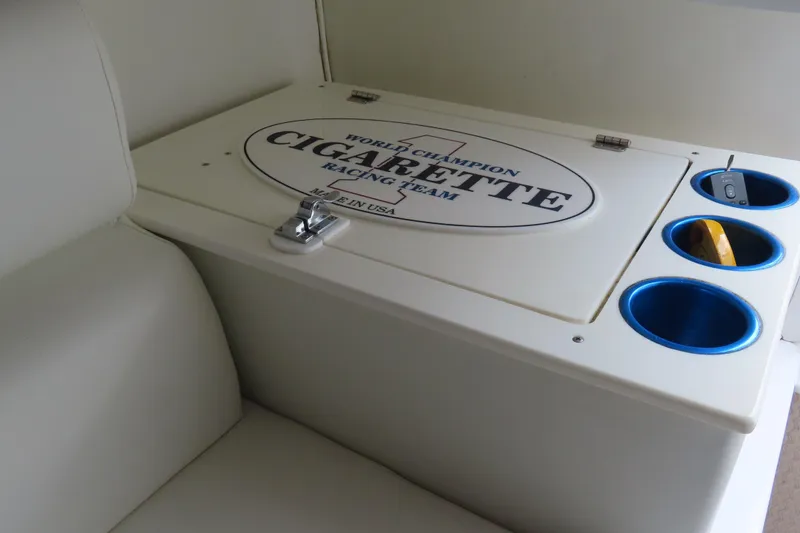 Slide: The Image of 2004 Cigarette 38 Top Gun TS boat interior with branded storage compartment and cup holders. - 23