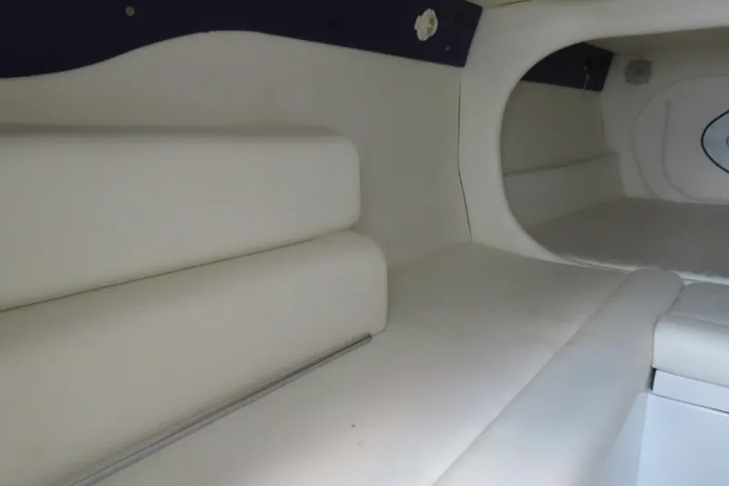 Slide: The Image of Interior cabin of a 2004 Cigarette 38 Top Gun TS boat, featuring white seating. - 26
