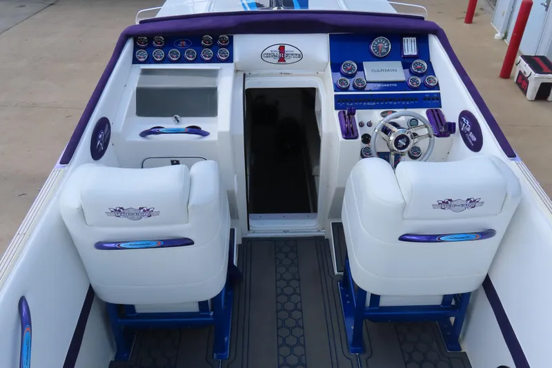 Slide: The Image of Interior of a 2004 Cigarette 38 Top Gun TS boat with white seating and control panel. - 7