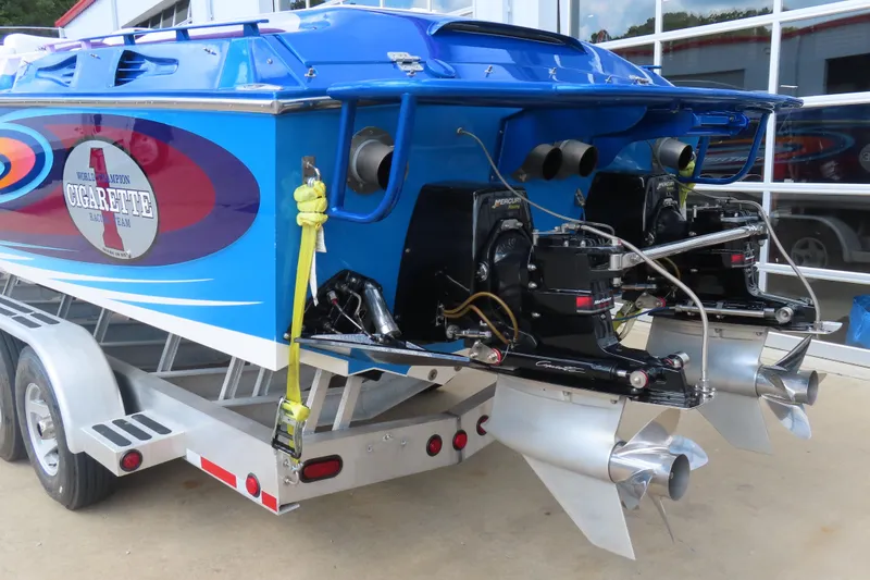 Slide: The Image of 2004 Cigarette 38 Top Gun TS boat on trailer, featuring dual Mercury engines. - 9