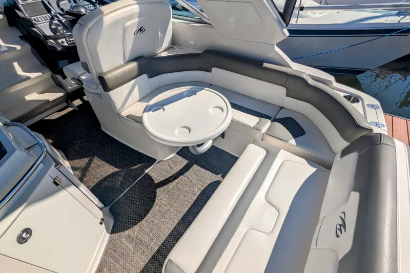Slide: The Image of 2013 Monterey 280 Sport Yacht interior with seating and table, showcasing luxury design. - 12