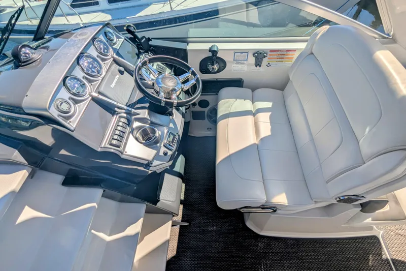Slide: The Image of 2013 Monterey 280 Sport Yacht cockpit with steering wheel and control panel. - 16