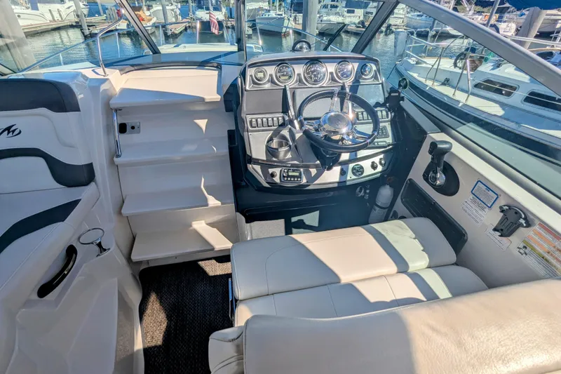 Slide: The Image of Interior cockpit of 2013 Monterey 280 Sport Yacht with steering wheel and control panel. - 17