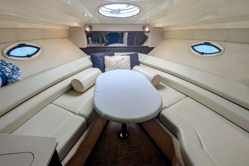 Slide: The Image of Interior of 2013 Monterey 280 Sport Yacht with plush seating and oval windows. - 24