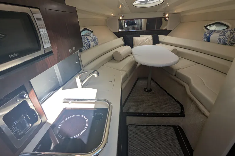 Slide: The Image of Interior of 2013 Monterey 280 Sport Yacht with kitchenette and seating area. - 25
