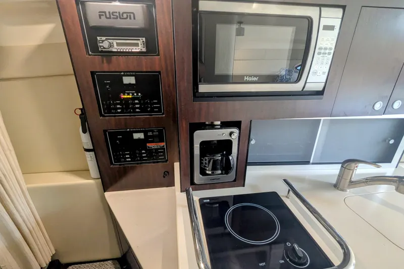 Slide: The Image of Interior of 2013 Monterey 280 Sport Yacht with kitchen appliances and control panels. - 27